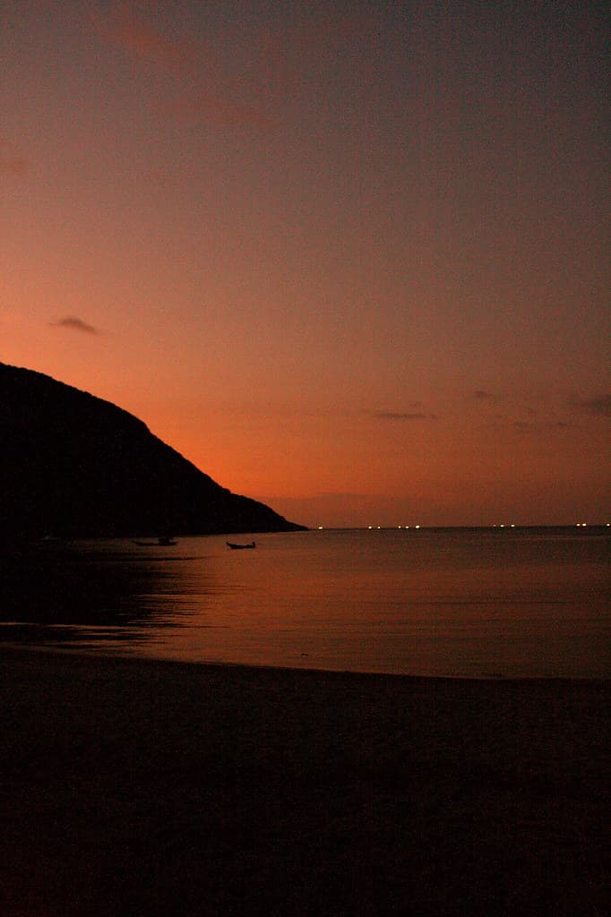 Bottle Beach sunset with calm water and island silhouettes