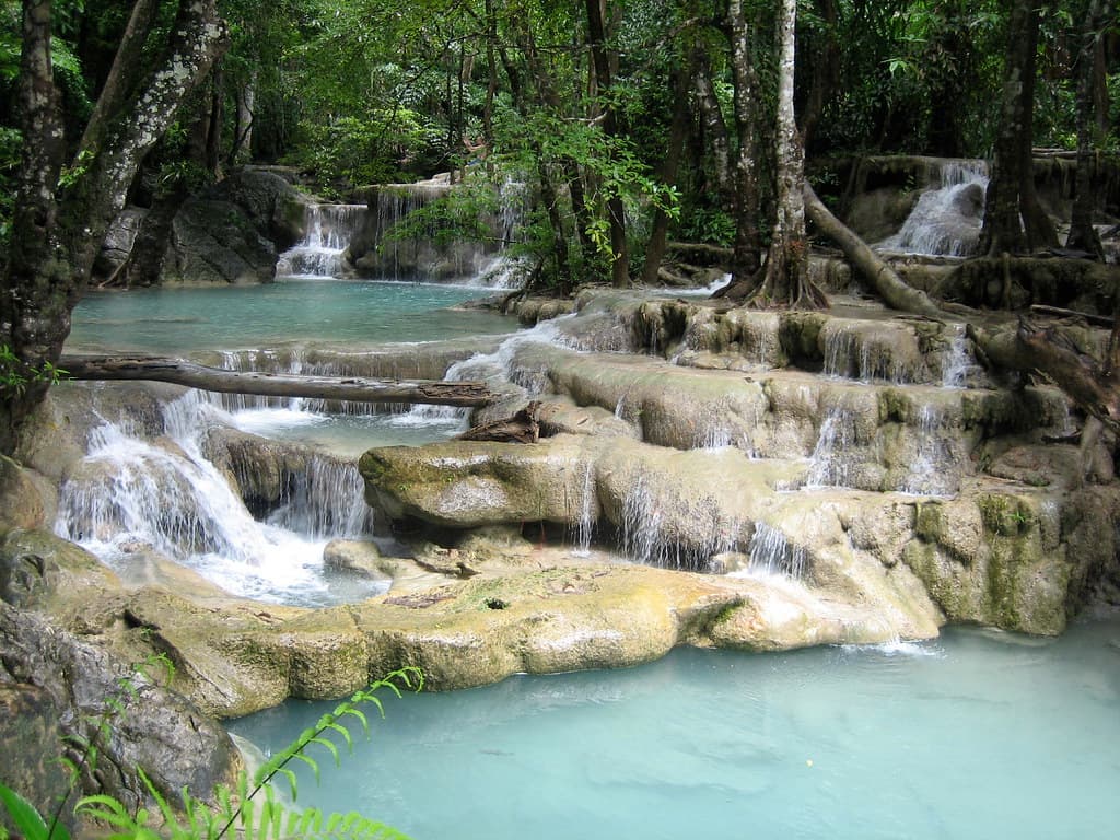 Tiered Thailand waterfall surrounded by lush forest